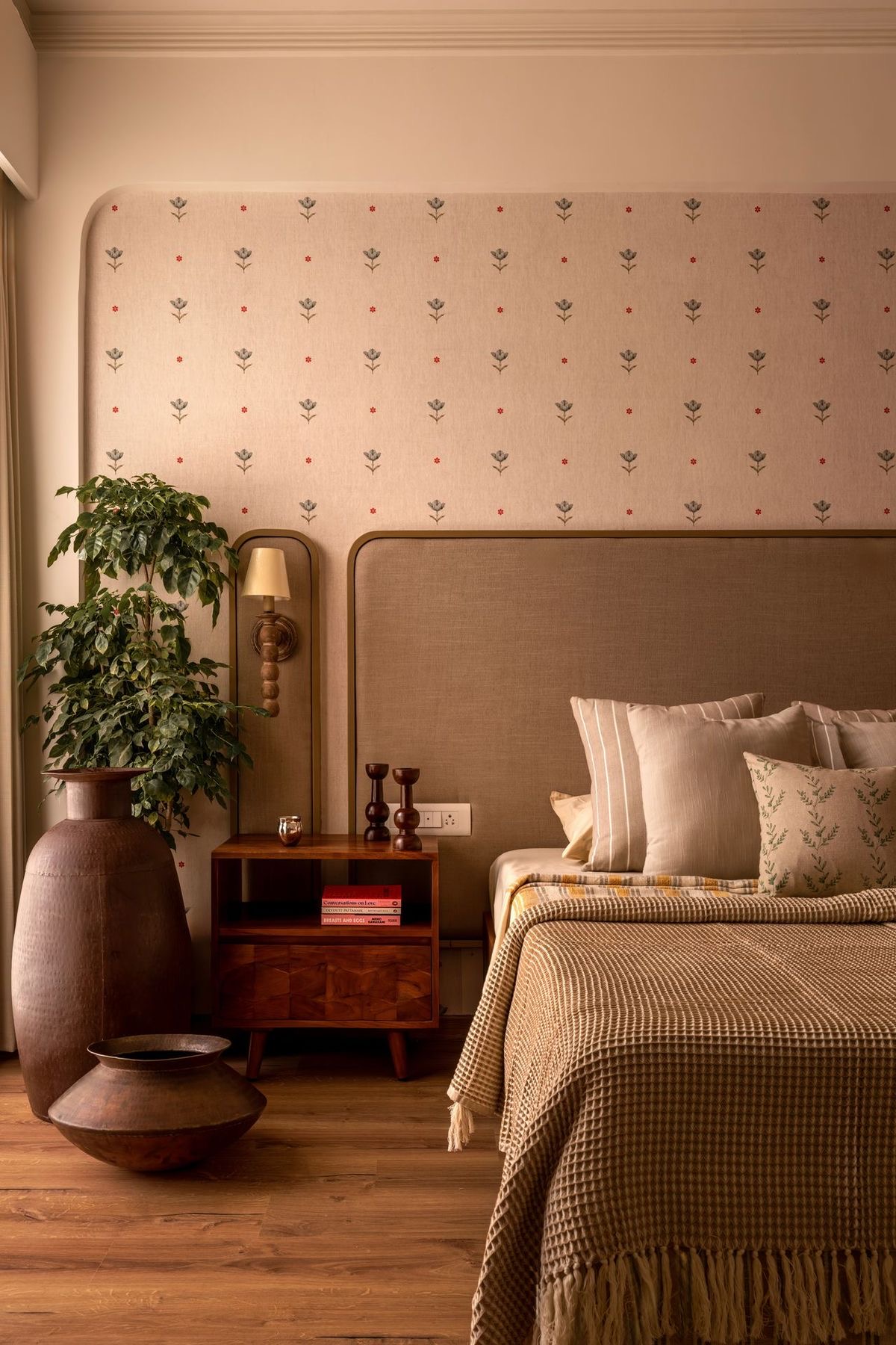 Earthy bedroom with block-print upholstered headboard wall