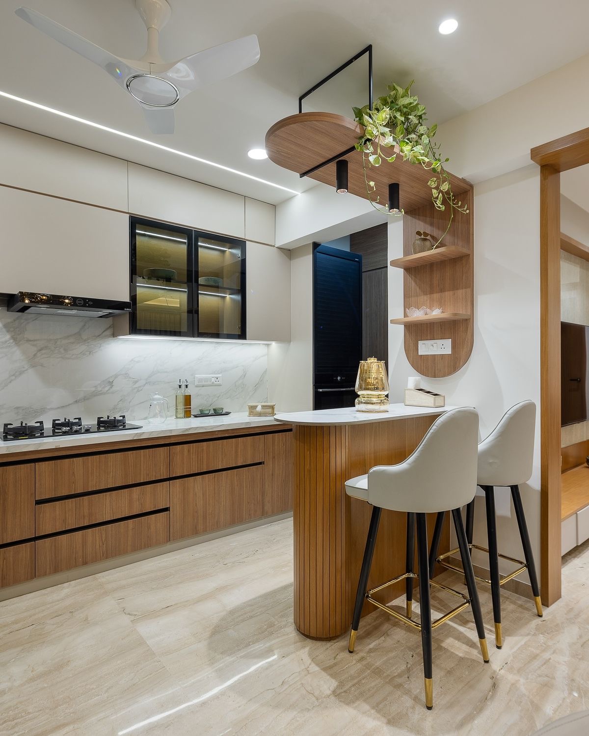 Modular kitchen with wood cabinetry and marble counter
